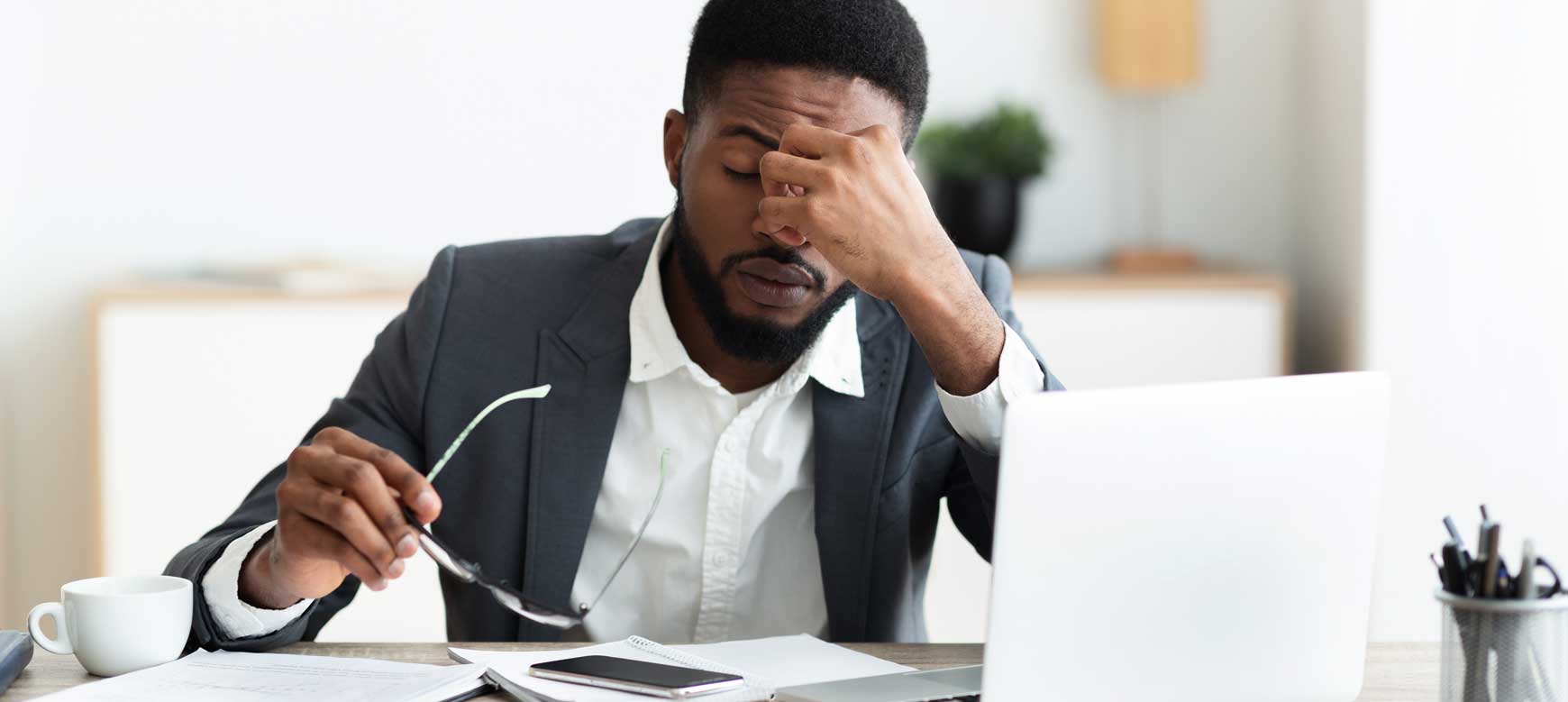 Stressed professional sitting in front of a laptop